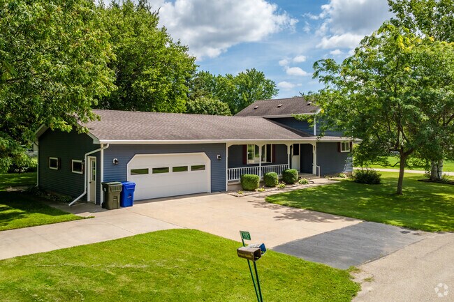 A split-level home with an attached garage and front porch in Butte Des Morts.