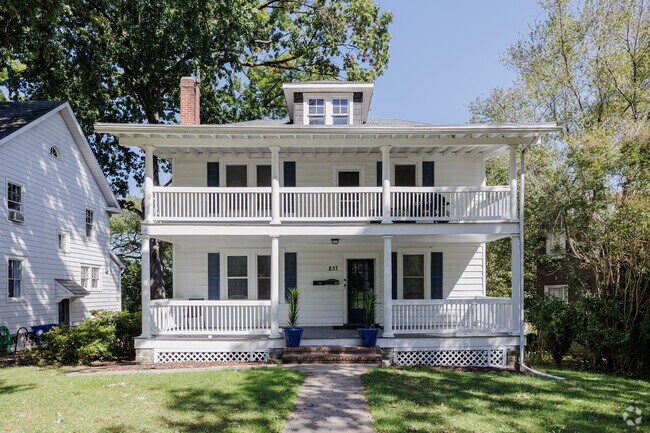 This two story home boasts two levels of porch in a prairie style design.