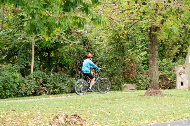 A cyclist enjoys riding along the Ralph Regula Towpath Trail near the Westarado neighborhood.