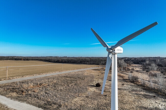 A wind turbine towers over southern Elk River as a sign of its renewable energy goals.