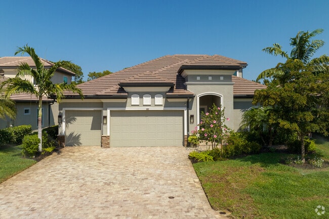 A double-garaged home with stoneworks in Moorings Park-Hawks Ridge.
