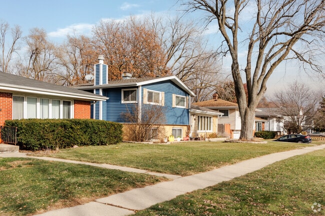 Front yards with neatly trimmed shrubs and ornamental trees are common in Mundelein Station.