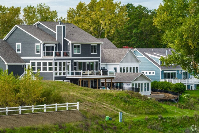A row of coastal style homes by the water in Newport Cove creates a playful atmosphere.