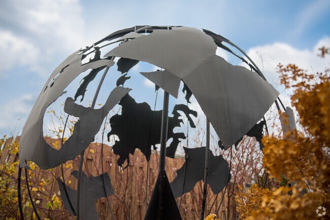 A globe sculpture is at the center of the Amhurst neighborhood.