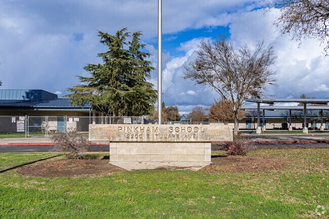 A large sign welcomes students to the entrance of Pinkham Elementary School in Visalia.