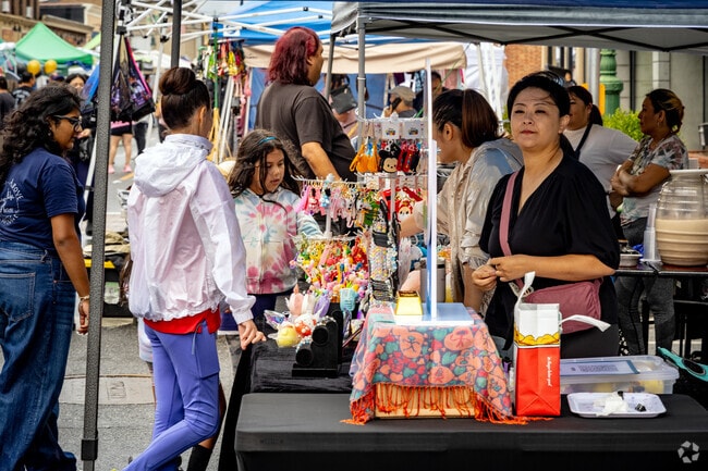 Residents stop by one of the many street vendors at the Westbury Street Fair.