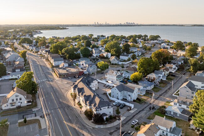 An aerial overview of the Adams Shore neighborhood in Quincy, MA with the Boston skyline.