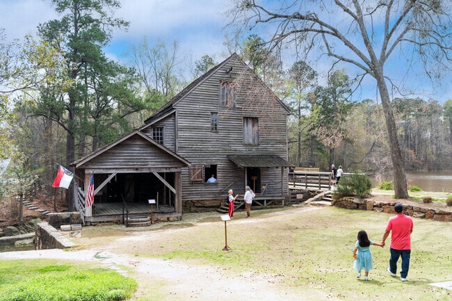 Families tour the historic gristmill at Historic Yates Mill County Park in South Raleigh.