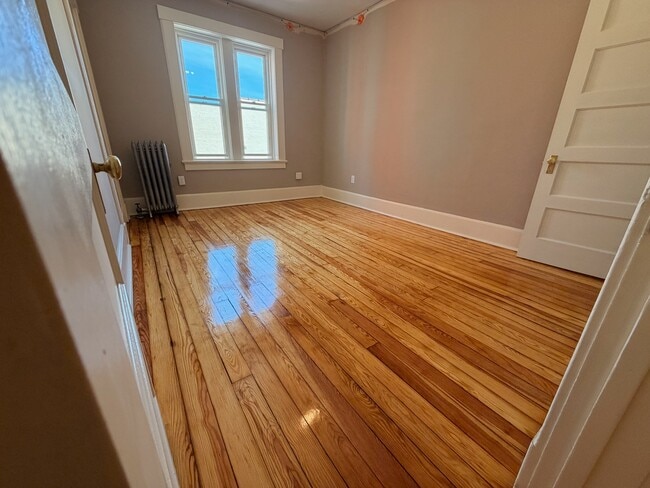 Large bedroom with hardwood floors