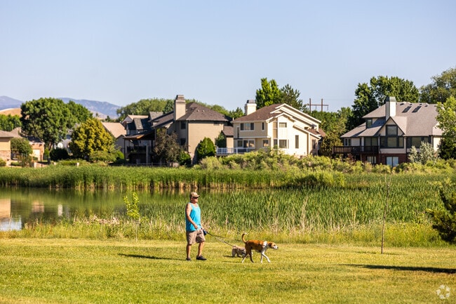 A man walks his dog along the scenic McIntosh Lake in Longmont Estates.