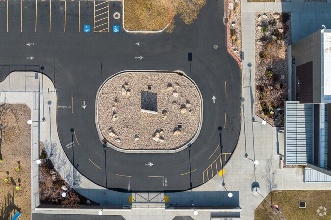 There is a circular drop off area in front of Liberty Elementary School.