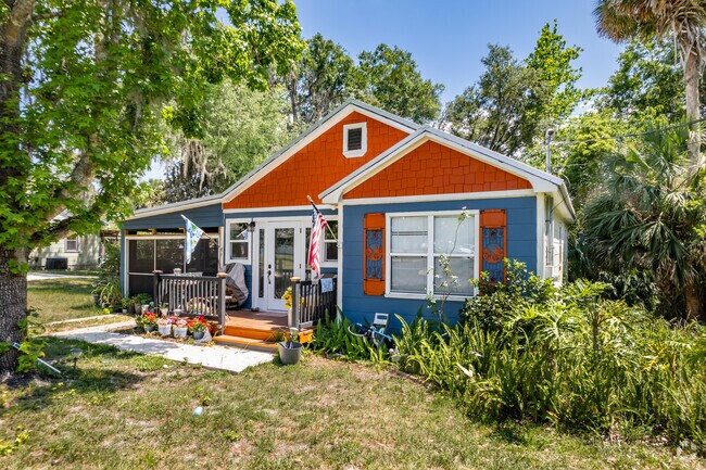 Colorful single-story home from the 70s with decorative trim contrasting shutters retro windows and carports in Umatilla.