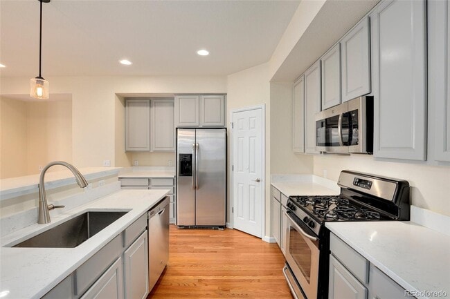 Spacious modern kitchen with Quartz countertops, gas range and SS appliances