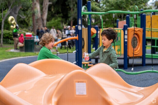 The sound of laughter echoes as children explore the playground, making new friends at Emery Park.