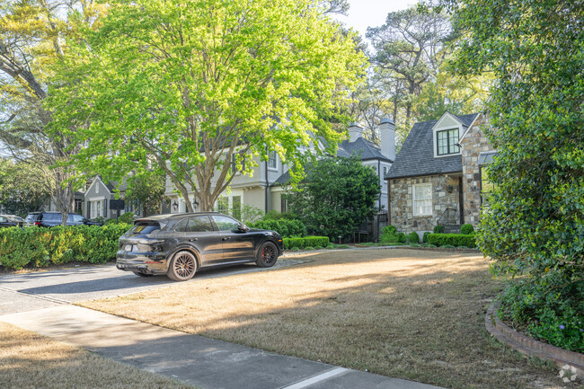 Homes in Peachtree Battle are shaded with lush leafy trees.