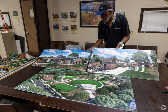 The Reverend at New Mt. Hermon Baptist Church shows plans for a new Eden Park in Boynton.