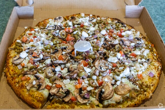 The Mediterranean pie at LampPost Pizza is fully loaded with Feta and Vegetables by Hidden Lake.