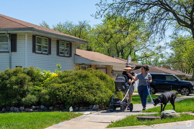 Hickory Hills residents take a walk with baby and dog in tow.