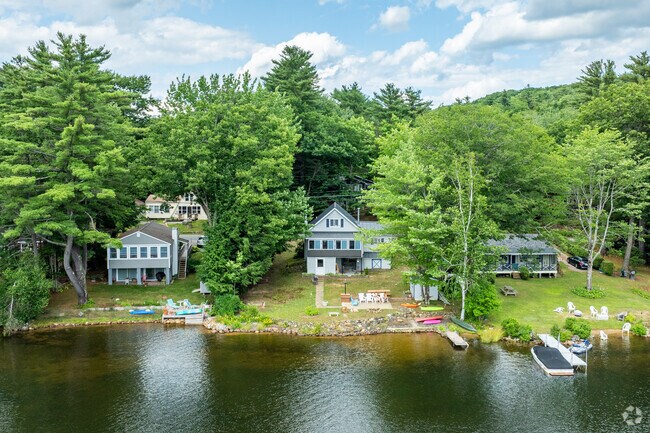 Many Colonial and Raise-Ranch homes with private access to the water sit along Lake Winnipesaukee near Laconia.