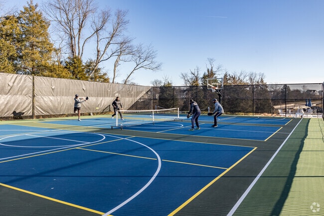Hartland residents stay active with friendly matches on the neighborhood pickleball court.