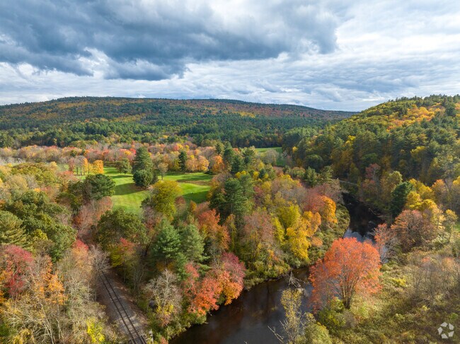 The rolling hills rise above the Ware River in New Braintree.