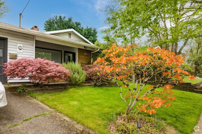 A blooming Rhodadedren add color to this updated mid century ranch in the Cathedral Park.