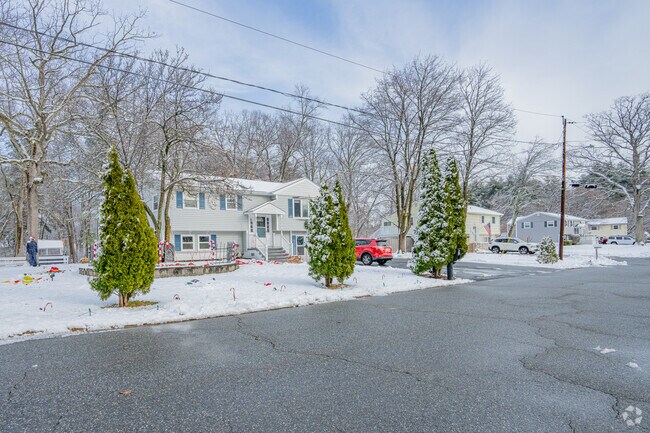 Tree-lined neighborhood streets frame Millville’s classic New England homes.