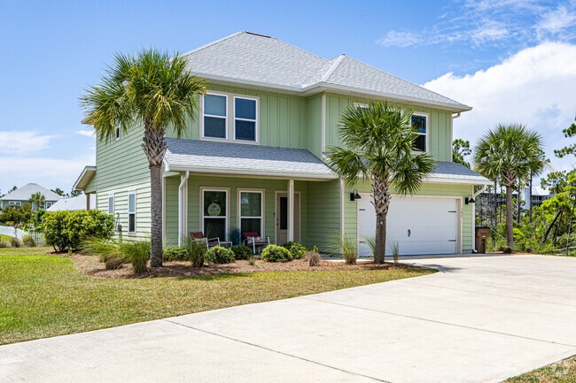 Palm trees and manicured landscaping enhance the curb appeal of this Indian Pass residence with a spacious driveway.