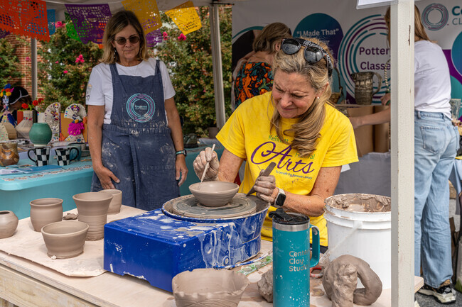 A potter shows off her technique to onlookers at the Kennett Square Arts Festival.