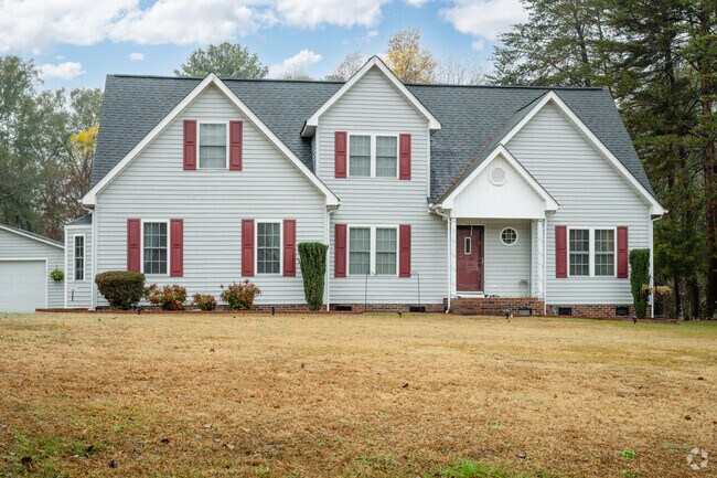A 2-story craftsman style home with a small porch and a large front yard in Catawba.