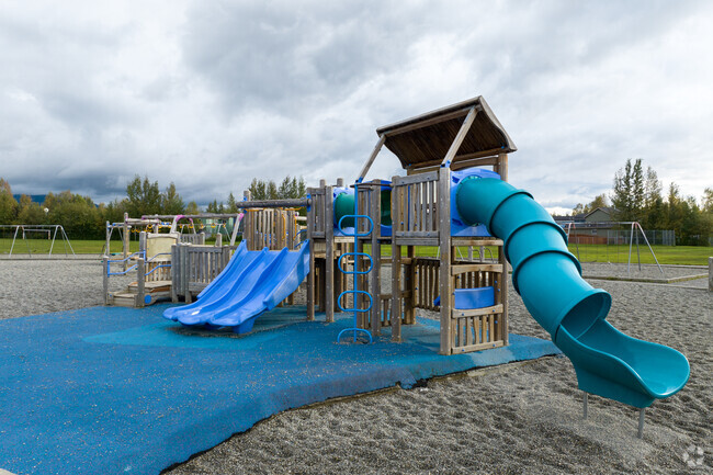 The playground at Kasuun Elementary has multiple slides and a treehouse theme.
