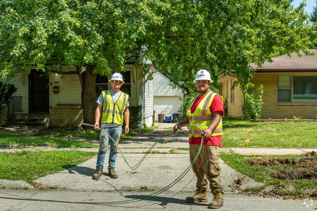 City workers lay down fiber optic cables in Highland Area.