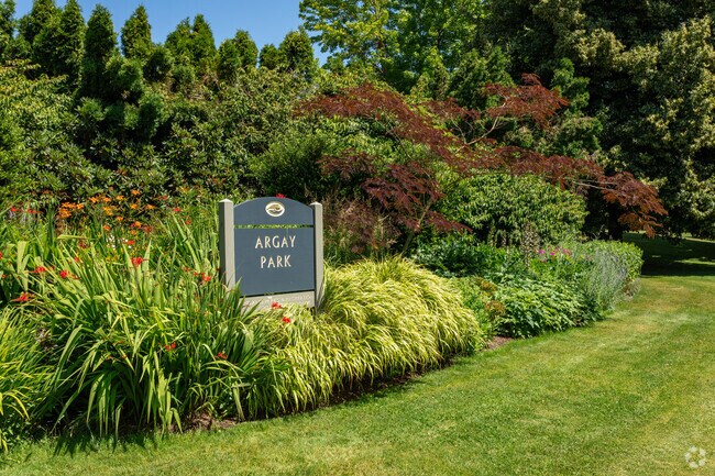 The Argay Park sign pops out of lush landscaping.