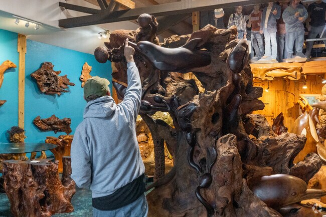 Customers enjoy stunning art pieces in the Brian McEney Woodcarving Gallery.