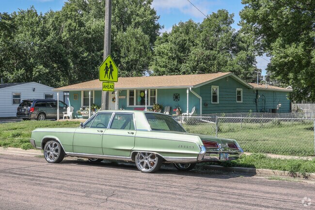 Classic homes in bold colors accented by classic cars give character to Garfield neighborhood.