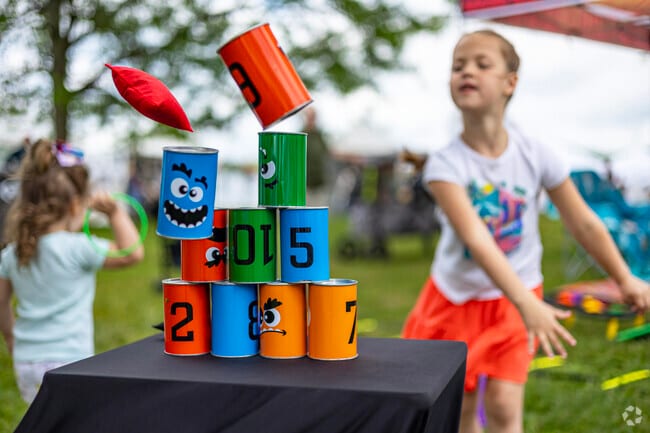 A playground and various lawn games provide distraction to kids attending Kensington Art Fair.