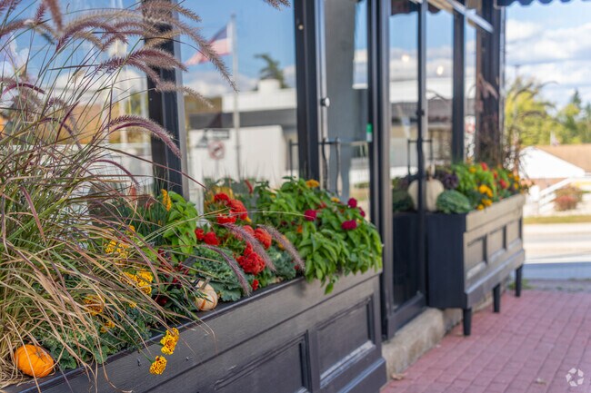The shops of Hardyston are decorated with flowers and planters.