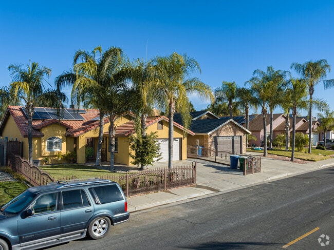 These Spanish style homes in East Delano have large mature palm trees for landscaping.