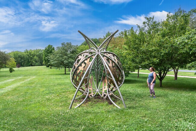 A woman checks out a sculpture in Meadowbrook Park near Historic East Urbana.