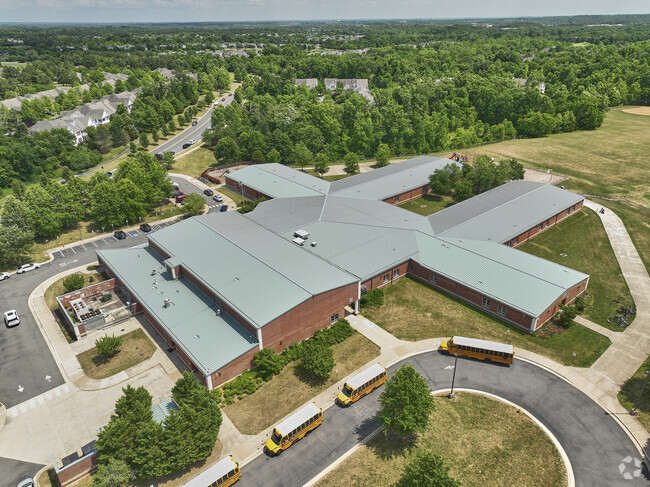 J.W. Alvey Elementary School is surrounded by lush greenery and a residential neighborhood.