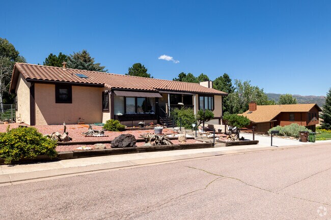 Ranch-style homes with clay tile roofs appear across Manitou Springs.