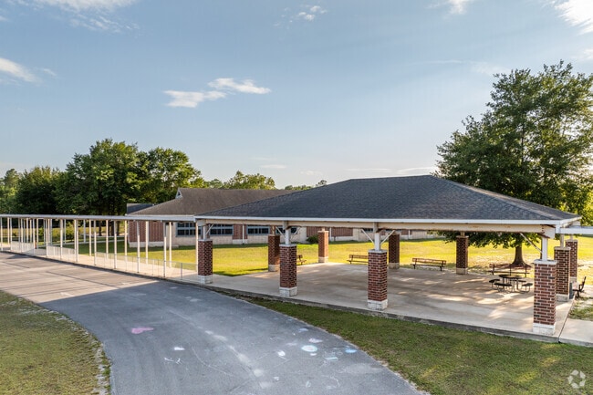 Students can wait for the pus out of the sun at MacClenny Elementary School.