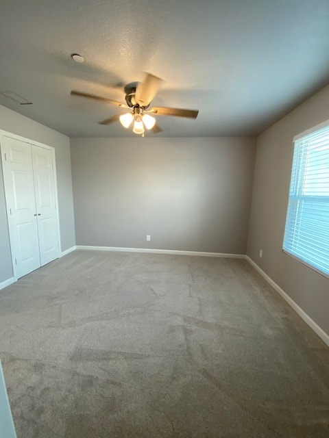 primary bedroom, carpet, ceiling fan, walkin closet and faux wood blinds
