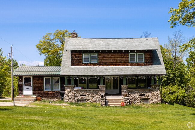 A Cottage style home with a stone porch can be found in Sebego.