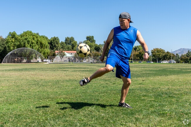 A man juggles a soccer ball at Canyon Country Park in Canyon Country.