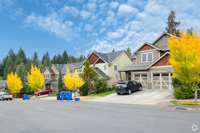 Contemporary homes pop with bright trees along Bluff Rd in Sandy.