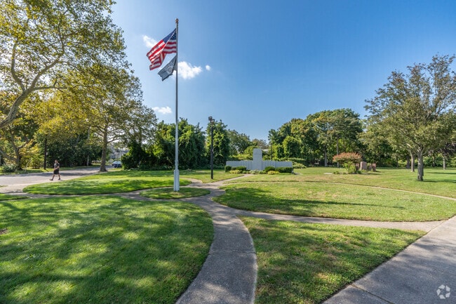 Fireman’s Memorial Park displays a flagpole and memorials dedicated to community service.