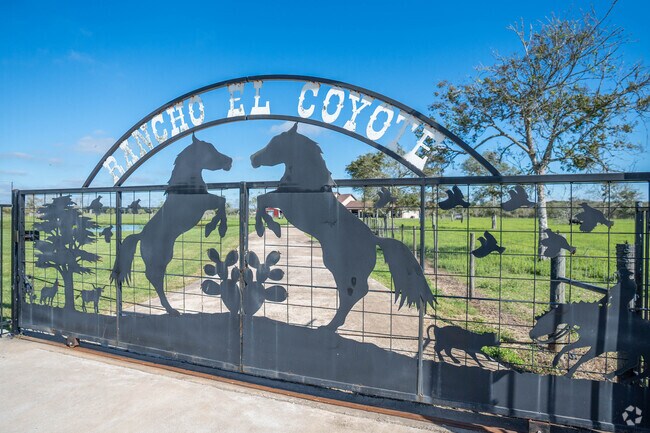 A ranch-style decorative gate marks the entrance to a large ranch-style home in Jones Creek.