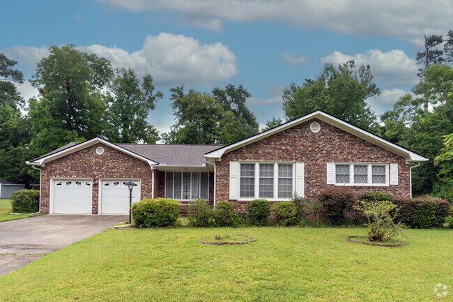 Midcentury ranch-style homes rest on spacious grassy lots in Masonboro.