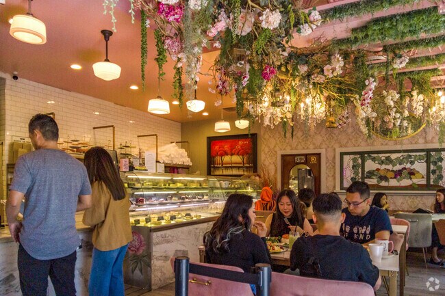 K Café Patisserie and Tea House with flower-filled pink dining room in Fruitdale neighborhood.